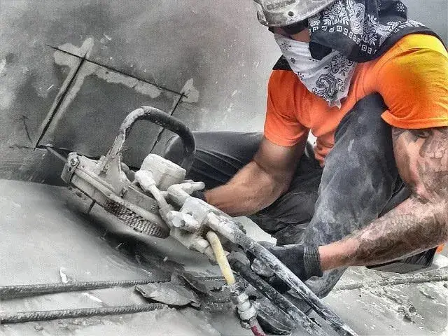 Chain Sawing scupper holes in a New Construction Site. 